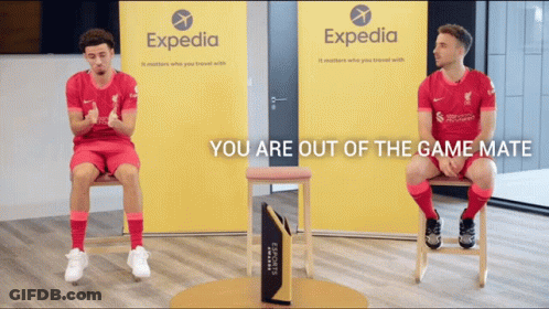 Two Soccer Players Are Sitting In Front Of A Expedia Sign GIF