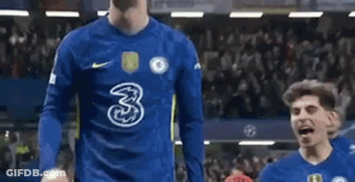 Two Soccer Players Are Standing On A Soccer Field . GIF