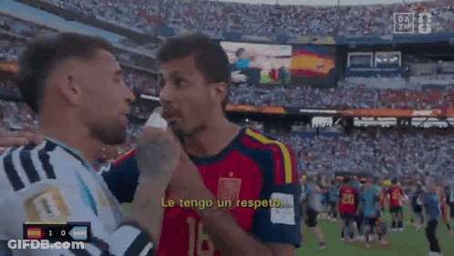 Two Soccer Players Are Talking To Each Other And One Of Them Is Wearing A Jersey With The Number 10 On It GIF