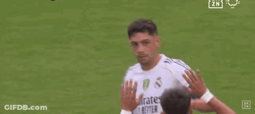 Two Soccer Players Are Walking On A Field And One Of Them Has The Number 8 On His Back . GIF