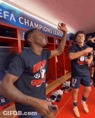 Two Soccer Players Celebrate Champions League Sign GIF