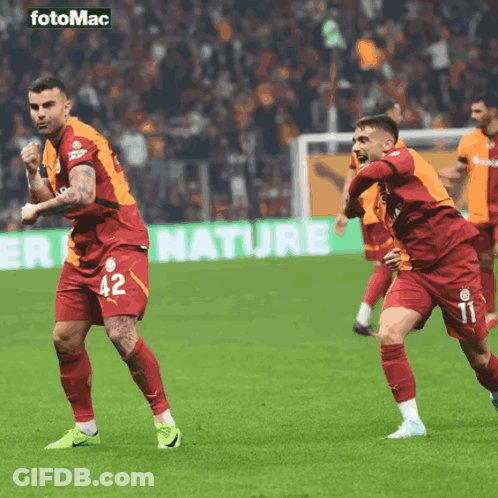 Two Soccer Players Celebrate Goal With Nature Ad GIF