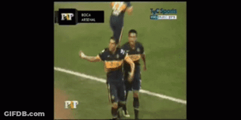 Two Soccer Players Celebrating Goal In Front Of TV Saying Pt GIF