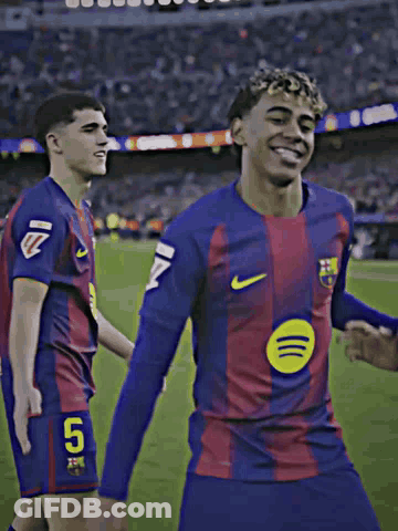 Two Soccer Players Dancing On Field, One In Spotify Shirt GIF