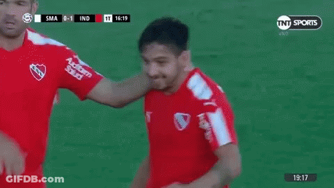 Two Soccer Players Fist Bumping GIF