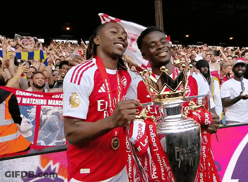 Two Soccer Players Holding Premier League Trophy GIF