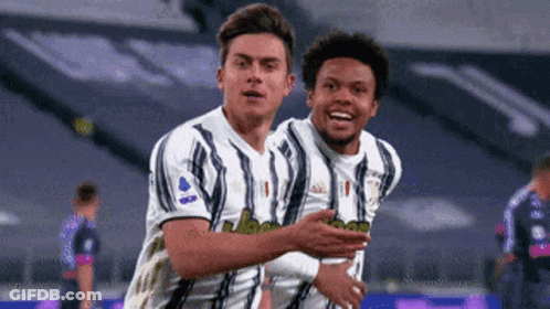 Two Soccer Players Hugging After Goal GIF