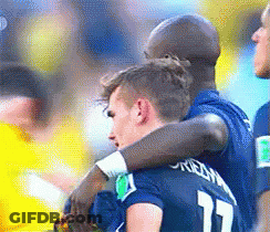 Two Soccer Players Hugging Each Other With One Wearing The Number 17 GIF
