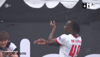 Two Soccer Players Hugging In Front Of Scoreboard Saying 0 GIF