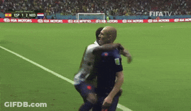 Two Soccer Players Hugging On A Field With A Kia Motors Banner In The Background GIF