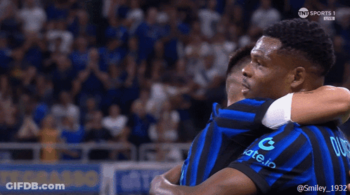 Two Soccer Players Hugging One With Letter G GIF