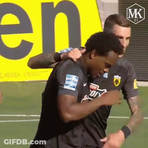 Two Soccer Players Hugging With MK Logo GIF