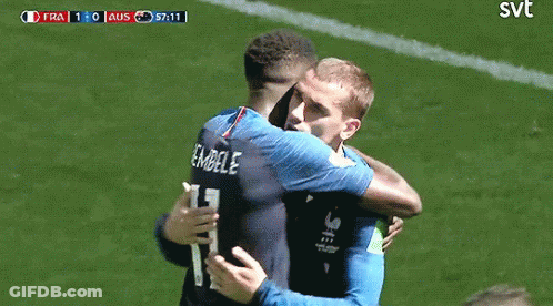 Two Soccer Players Hugging With SVT Logo On Field GIF