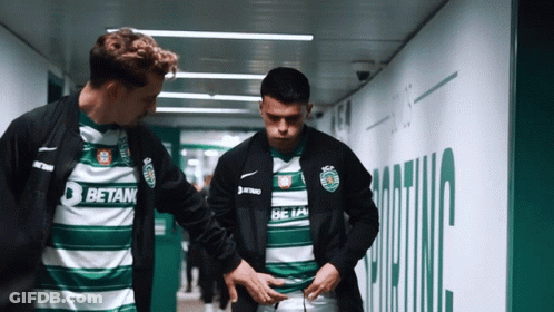 Two Soccer Players In Betan Jerseys In Tunnel GIF