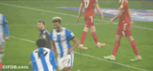 Two Soccer Players In Blue And White Striped Uniforms Number 7 GIF