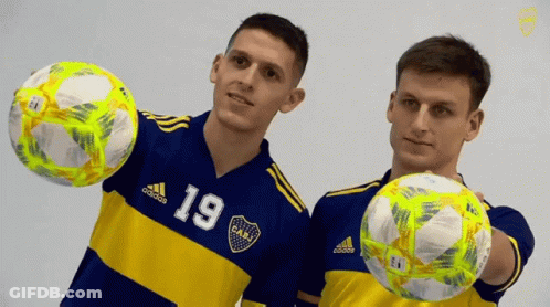 Two Soccer Players In Blue And Yellow Jerseys Number 19 GIF
