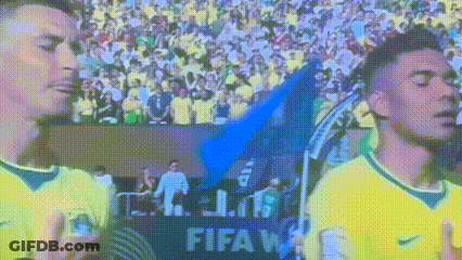 Two Soccer Players In Front Of FIFA Sign GIF