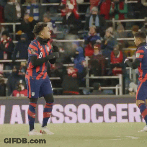 Two Soccer Players In Front Of Soccer Sign GIF