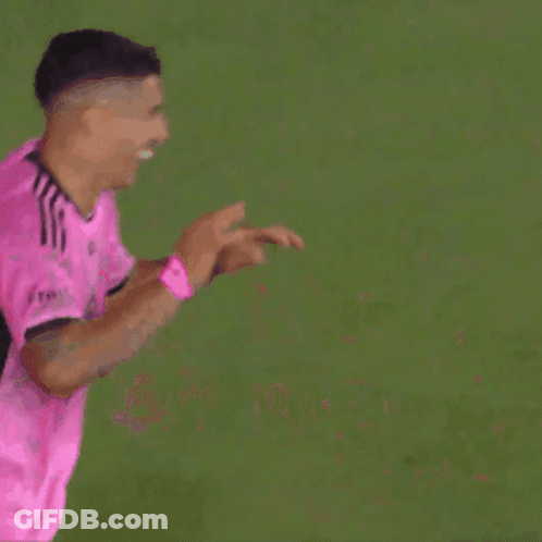 Two Soccer Players In Pink Jerseys High Five GIF