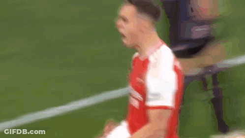 Two Soccer Players In Red And White Fighting GIF