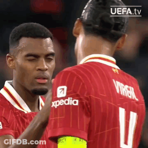 Two Soccer Players In Red Jerseys GIF