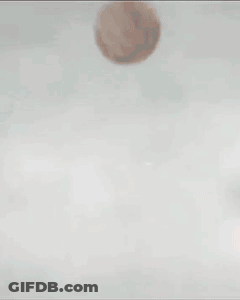 Two Soccer Players In Red Jerseys And Blue Shorts Kick A Ball GIF