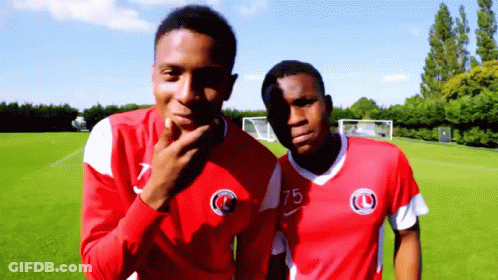 Two Soccer Players In Red Jerseys Number 75 GIF