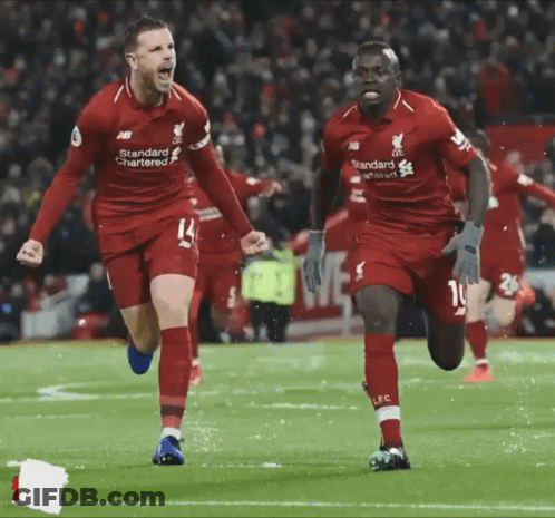 Two Soccer Players In Red Standard Chartered Jerseys GIF