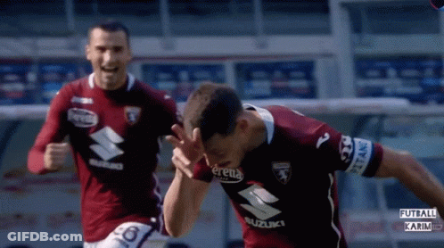 Two Soccer Players In Suzuki Jerseys Running GIF