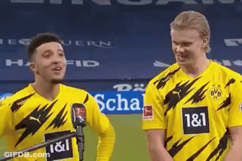 Two Soccer Players In Yellow Jerseys Standing On Field GIF