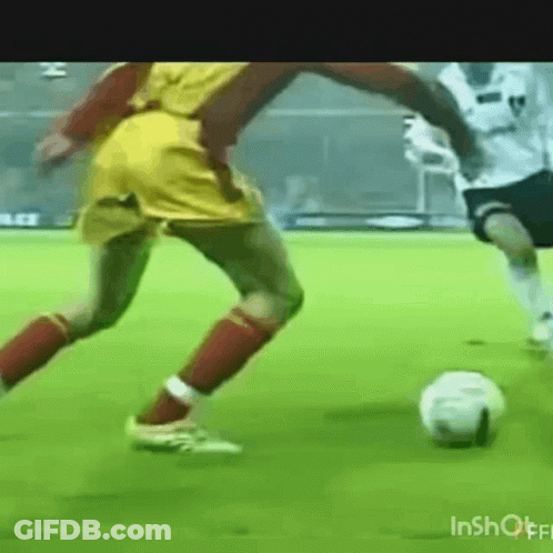 Two Soccer Players Kicking Ball GIF