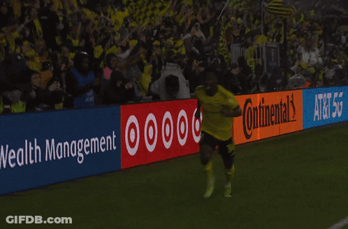Two Soccer Players Kneeling In Front Of Continental Sign GIF