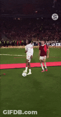 Two Soccer Players On A Field With A Banner In The Background That Says Maker O GIF