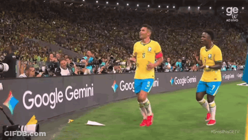 Two Soccer Players On A Field With A Google Gemini Banner GIF