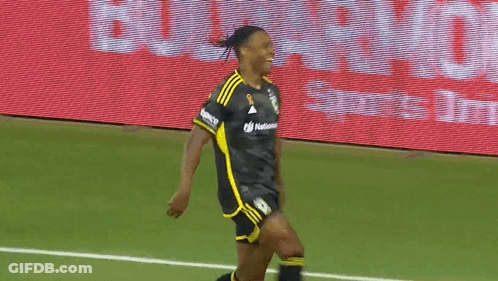 Two Soccer Players On A Field With A Lowe Sign Behind Them GIF