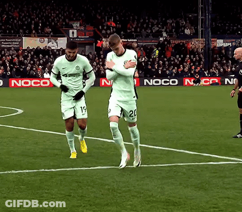 Two Soccer Players On A Field With A Noco Ad Behind Them GIF