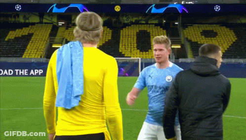Two Soccer Players On A Field With A Sign That Says " Load The App " GIF