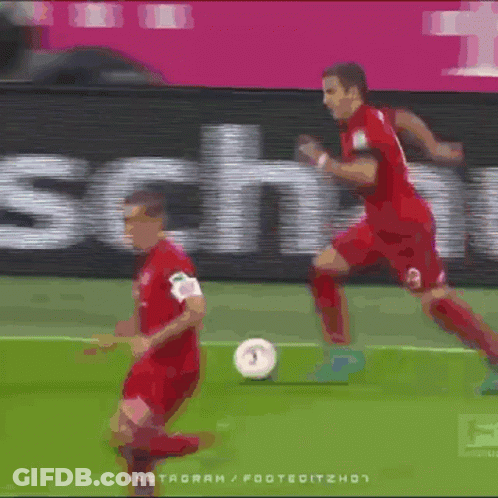 Two Soccer Players On A Field With A Sign That Says T-Mobile GIF