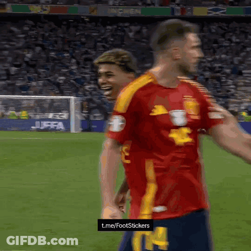 Two Soccer Players On A Field With A T.me/footstickers Sign GIF