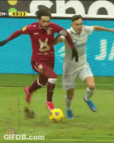 Two Soccer Players On A Field With The Time 03:12 In The Background GIF
