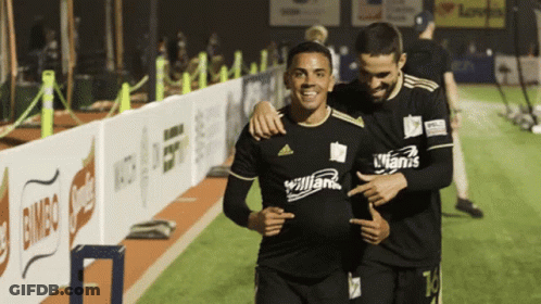 Two Soccer Players One Wearing A Jersey That Says Allianz On It GIF