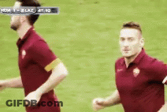 Two Soccer Players Running During Roma Vs Lazio Game GIF