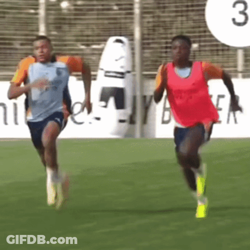 Two Soccer Players Running On A Field With The Number 3 Behind Them GIF