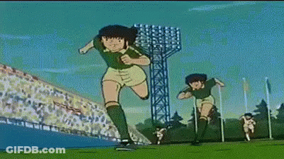 Two Soccer Players Running On Field With Crowd GIF