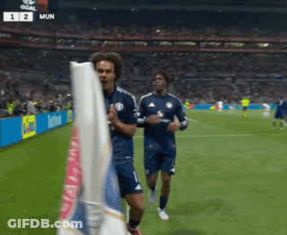 Two Soccer Players Running On Field With Scoreboard Saying Mun GIF