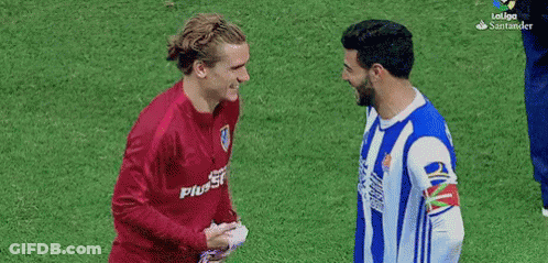 Two Soccer Players Shaking Hands One In Plus500 Shirt GIF