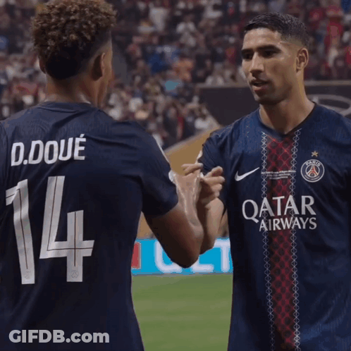 Two Soccer Players Shaking Hands With One Wearing The Number 14 GIF