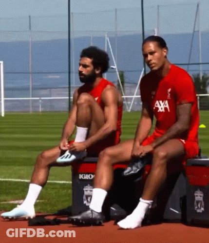 Two Soccer Players Sit On A Cooler That Says Igloo GIF