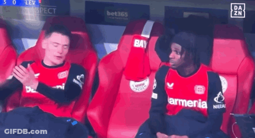 Two Soccer Players Sitting In Stands One With Armenia On Shirt GIF