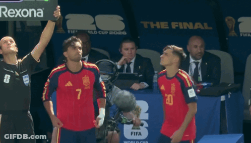 Two Soccer Players Stand In Front Of A Fifa World Cup Sign GIF